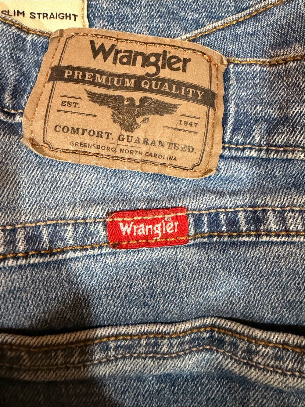 Wrangler Light Blue Denim Jeans with Red Logo Tab and Tan Leather Patch